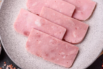 Delicious canned pink ham with salt, spices and herbs