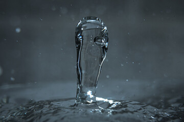 Liquid drop on the water surface. Splash. Chemistry.
