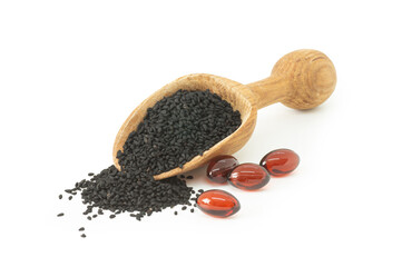 Pills of black cumin seeds essential oil isolated on white background. Nigella Sativa capsules, healthy food supplement