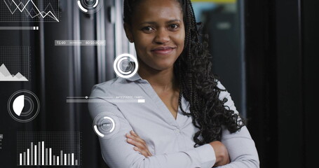 Image of data processing and diagrams over biracial female worker smiling in server room