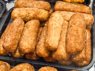 Crispy golden snacks piled high at a bustling street market