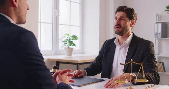 Successful lawyer or attorney shakes hands with a client in the office after signing a contract. The handshake symbolizes agreement, collaboration, and a successful business partnership in law.
