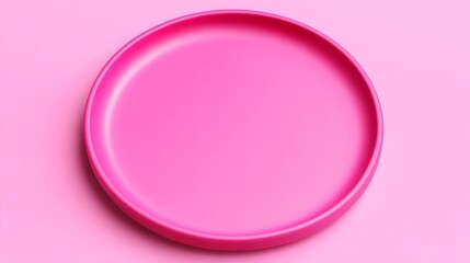 Obraz premium Bright pink circular plate on a pastel pink background, ideal for food presentation or decor