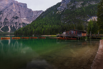 Lago di Braies Pragser Wildsee with wooden fisherhut lake mountain lake and the wooden boats in the foreground