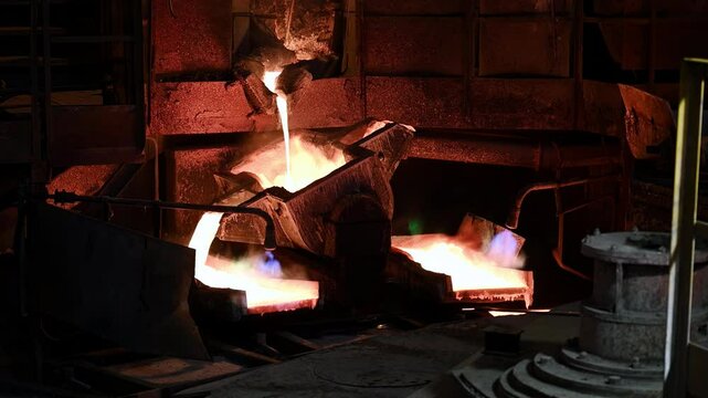Pouring liquid copper in casts on carousel machine at plant