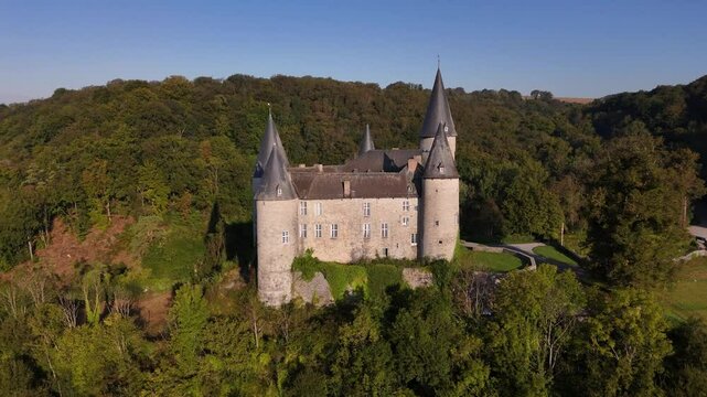 Discover the enchanting beauty of Veves Castle in Belgium at sunset