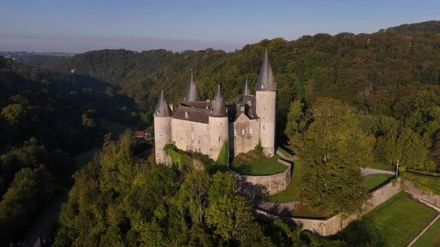 Enchanting views of Veves Castle amidst lush Belgian landscape
