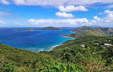 Tropical Caribbean landscape with lush green hills and blue ocean views