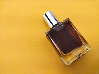 blank  glass perfume bottle on brown paper background