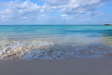 Tropical paradise beach with white sand and blue sky.