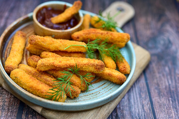  Crispy home made  deep fried   chicken strips . Breaded  with cornflakes chicken  breast fillets  with chilly peppers and fresh   basil on wooden rustic background
