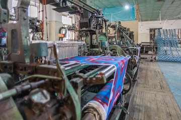 A beautiful carpet on a loom during the sewing process.
