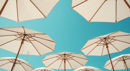 Serene canopy of sun umbrellas against a vibrant cerulean summer sky
