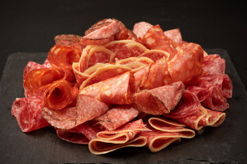 Different kinds of meat cuts on a board.