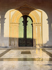Beautiful arched doorway with shadows of Roman columns