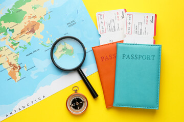 Travel agency. Flat lay composition with flight tickets on yellow background