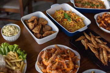 Various dishes with shrimp and seafood served on a table