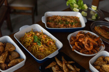 Various dishes with shrimp and seafood served on a table