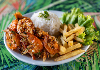 Brazilian dish made of shrimp with rice and fries
