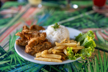 Brazilian dish made of fish with rice and fries