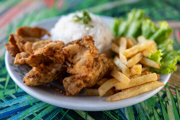 Brazilian dish made of fish with rice and fries