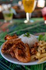 Brazilian dish made with garlic and oil shrimp with rice and potatoes, everyday food