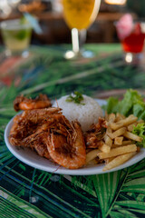 Brazilian dish made with garlic and oil shrimp with rice and potatoes, everyday food