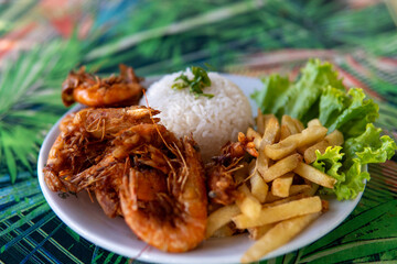 Brazilian dish made with garlic and oil shrimp with rice and potatoes, everyday food