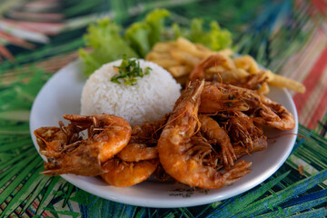 Brazilian dish made with garlic and oil shrimp with rice and potatoes, everyday food