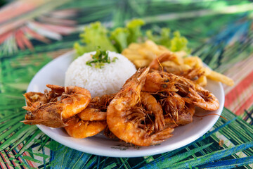 Brazilian dish made with garlic and oil shrimp with rice and potatoes, everyday food