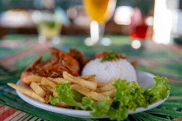 Brazilian dish made with garlic and oil shrimp with rice and potatoes, everyday food