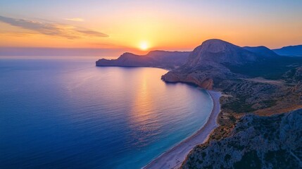 Aerial View of a Serene Sunset over a Secluded Beach and Coastal Hills