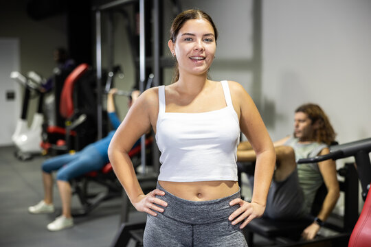 Caucasian woman fitness trainer standing in gym