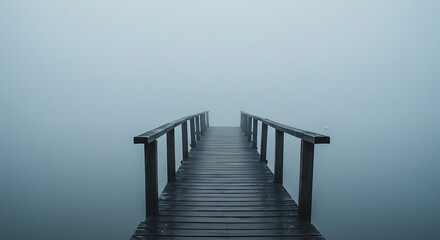 Obraz premium Walking Wooden Pier Disappearing Into Thick Fog Over Calm Water