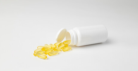 Mockup of a white bottle of omega 3 capsules, food supplement, lying down on white background with copyspace