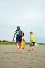 Bright mother and child leave the sunny beach for home