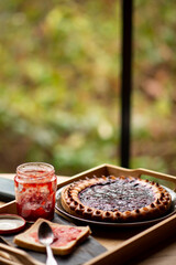Homemade pie with jam on wooden table
