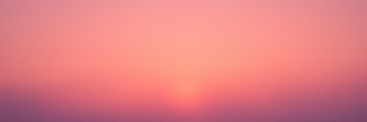 Soft mauve clouds scattered across a warm orange sky at sunset, scattered clouds, clouds