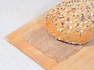 Light grain bread on a wooden kitchen board.
