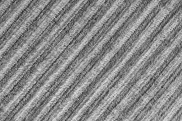 Ridge macro texture of velour corduroy gray cloth. Large ribbed, diagonal coarse weaving velveteen, striped upholstery texture fabric background, furniture textile material, design, decor