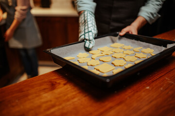 Fototapeta premium Baking freshly shaped cookies in a cozy kitchen