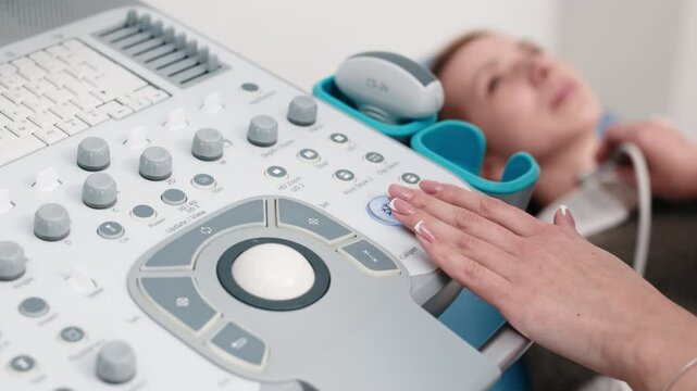 Close-up of a thyroid ultrasound. A doctor in blue gloves moves the probe on a young patient&rsquo;s neck. The concept of modern technology and precision in endocrine diagnostics.