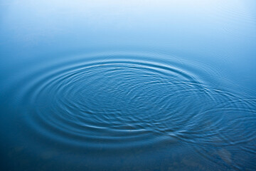 Circular water ripples and bubbles effect. Water ripples and round droplets on blue sea texture...