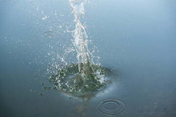 Water drops splash, ripples and bubbles effect. Water splash and ripples on blue sea texture pattern background. Liquid motion on calm lake surface. Ring affect, circles, round droplets 