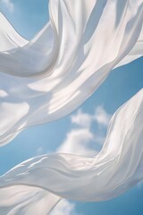 Billowing white fabrics swaying in the wind against a serene blue sky with soft sunlight