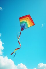 Colorful rainbow kite flying in the clear blue sky with copy space
