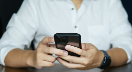 Businessman holding a smartphone for communication