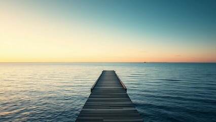 Obraz premium A tranquil coastal scene with a minimalist jetty extending into the sea, bathed in the gentle glow o