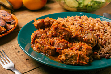 Rice congri with pork fricassee, salad and fried ripe plantain. Typical Cuban food