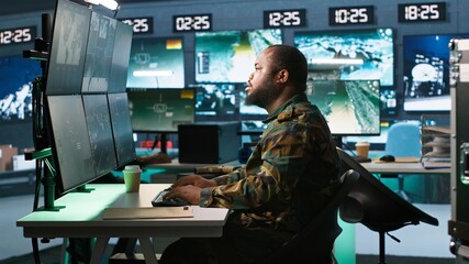 Army expert working in governmental facility operating surveillance tech, evaluating target data....